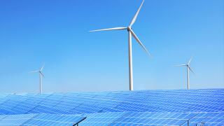 Solar panels and wind turbines in field. Concept of eco friendly thechnologies