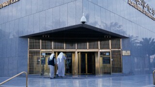 KUWAIT Middle East Gulf State Kuwait City Exterior of Al Ahli Bank of Kuwait with two men about to enter