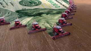 Mass soybean harvesting at a farm in Mato Grosso state,Brazil. Concept commodities with agribusiness, and dollar banknote.