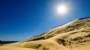 Kelso Dunes, also known as the Kelso Dune Field, is the largest field of aeolian sand deposits in the Mojave Desert. The region is protected by the Mo