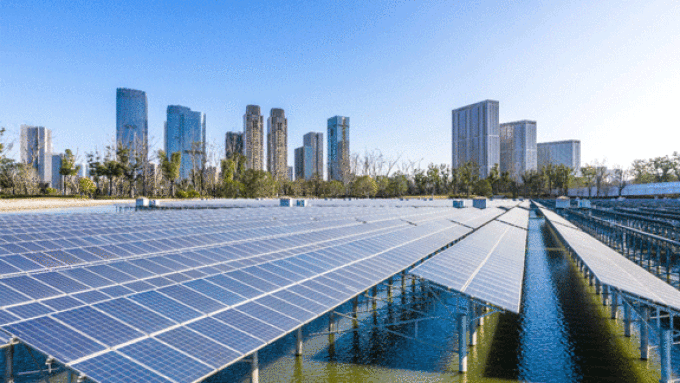 solar panels in water with cityscape in background