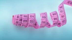 Coiled pink textile tape measure