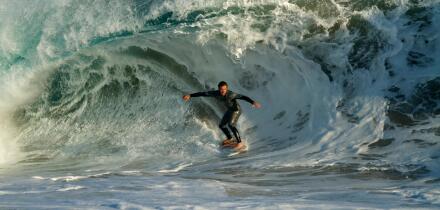 Surfers riding the huge surf created by Hurricane Marie in the Pacific Ocean at the Wedge in Newport Beach Southern California