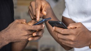 two young african people people using their mobile phones, trans