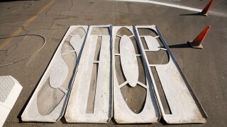 Wood stencils for painting STOP on pavement laying on asphalt street with orange traffic cones Indio California USA. Image shot 2009. Exact date unknown.