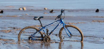 Bike stuck in river mud at New Brighton, Mereyside.