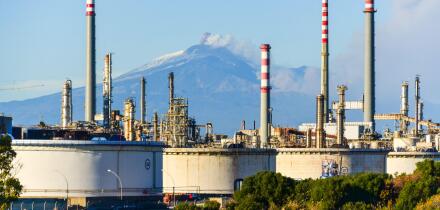 Railway by the Enel powerplant between Catania and Syracuse, Sicily, Italy, as the Mount Etna erupts