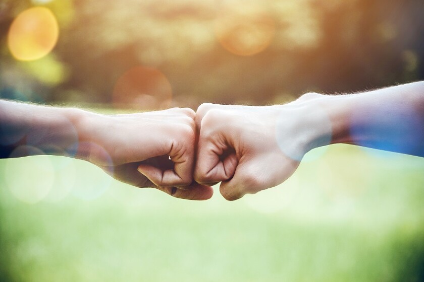 Hands of two man people fist bump team teamwork and partnership business success. Volunteer charity work. People joining for cooperation mergers and acquisitions concept