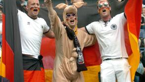 (dpa) - German soccer fans cheer prior to the match Germany vs Australia at the FIFA Confederations Cup in Frankfurt, Germany, 15 June 2005. Fan in center wears a kangaroo costume.