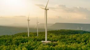 Wind energy. Wind power. Sustainable, renewable energy. Wind turbines generate electricity. Windmill farm on mountain with sunset sky. Green technology. Renewable resource. Sustainable development.