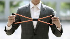 Businessman exercising with resistance band