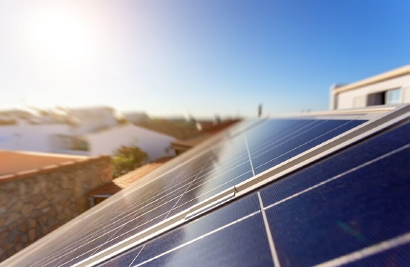 Solar energy storage panels on the roof of a house in a Portuguese city. Clean green energy