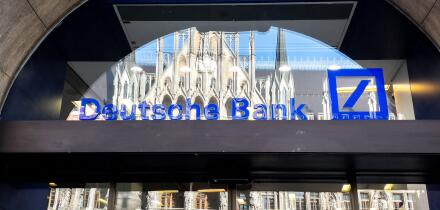 Deutsche Bank logo on the window of a branch in Munich