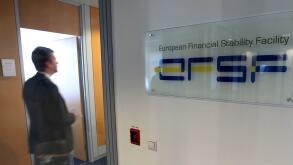 A man walks past at the entrance of the European Financial Stability Facility office in Luxembourg, Monday Oct. 3, 2011. After the Oct. 23 summit of EU leaders, the EFSF will wield massive financial power to contain the eurozone's debt troubles and keep t