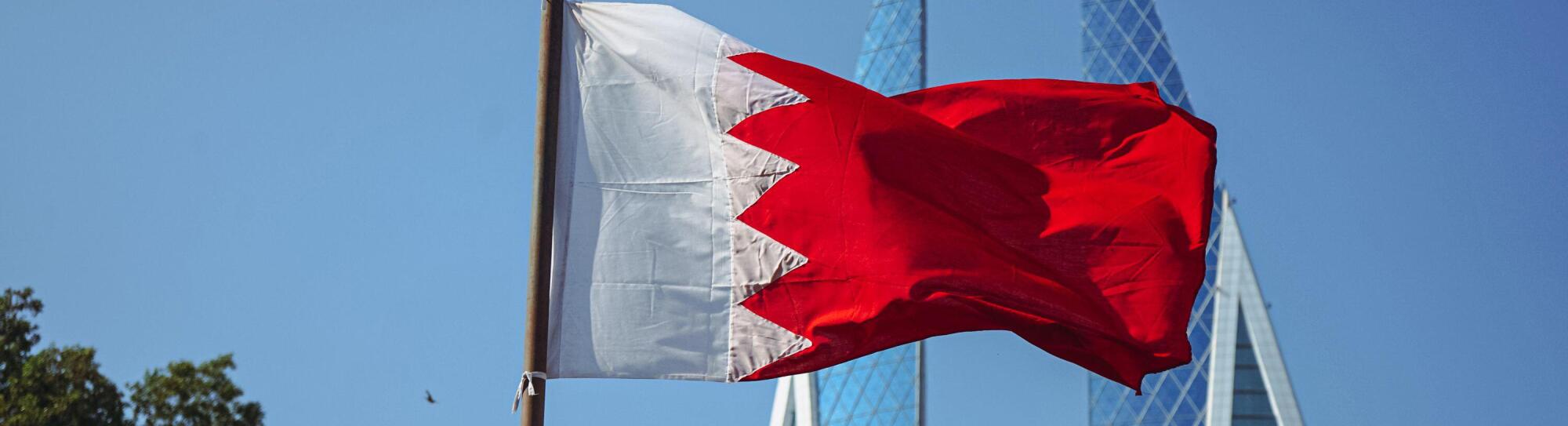 The national flag of Bahrain and Bahrain World Trade Centre.f