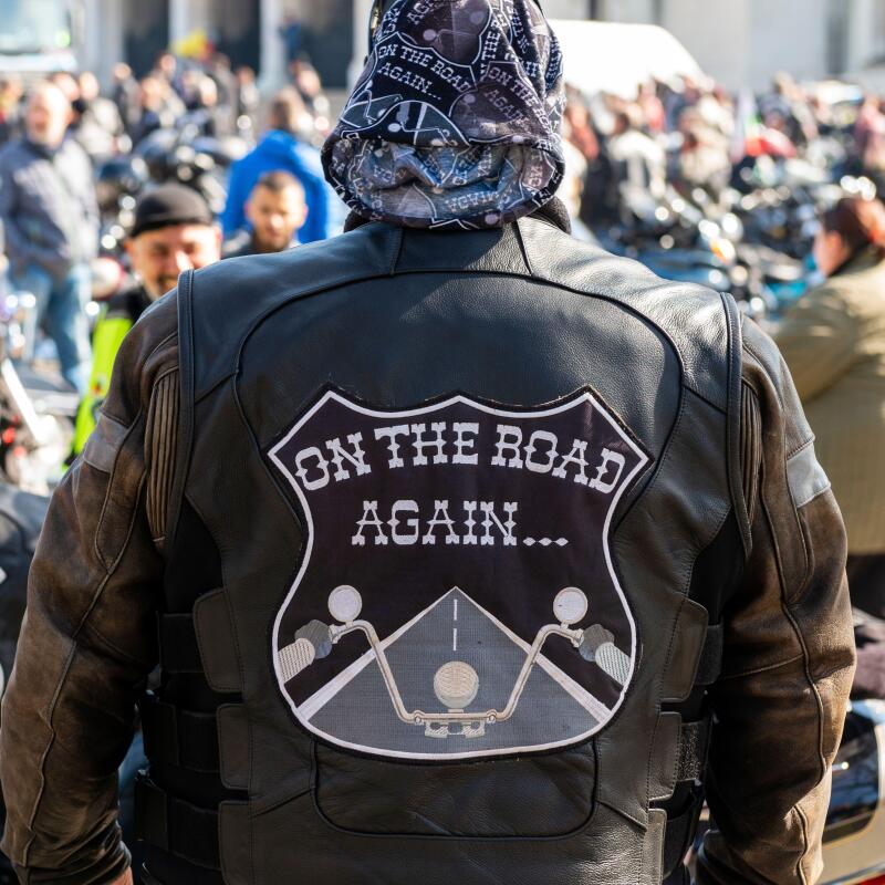 Biker wearing leather jacket with On The Road Again emblem at the annual motorcycle bike fest gathering and parade for bikers in Sofia, Bulgaria