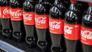 Belarus, Minsk - 30 april, 2024: A neat row of several CocaCola bottles is arranged on a shelf, showcasing the iconic drink. The display features seve