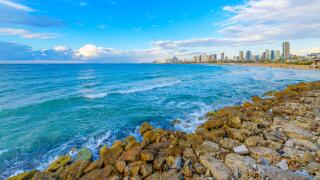 View of the coastal city skyline and beaches of Tel Aviv, Israel, from the ancient city of Jaffa, along the Mediterranean Sea.