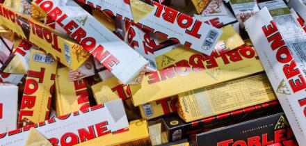 Kiel, Germany - 18. June 2025: Many Toblerone chocolate bars stacked together, creating a mountain of sweet treats