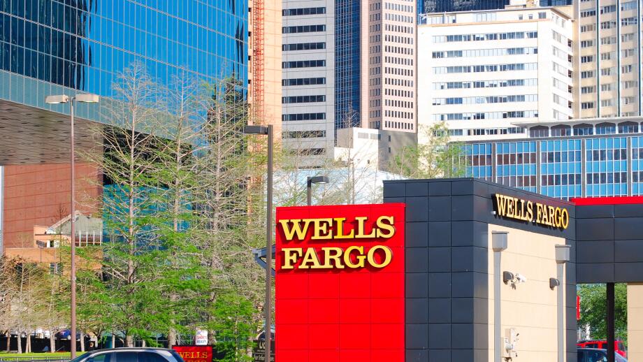 Wells Fargo branch in downtown Dallas, Texas with skyscrapers and office buildings in the background.