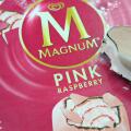 A Magnum Ice cream lolly with a bite out of it, in pink raspberry flavour.