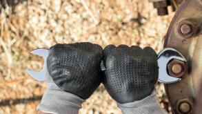 Hands with Work Gloves Holding a Wrench and Tighten very Rusty Bolts