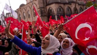 Supporters of Turkish President and People's Alliance's presidential candidate Recep Tayyip Erdogan gesture as they listen to his speech during an election rally campaign in Istanbul, Turkey, Friday, April 21, 2023. Presidential elections in Turkey are sc