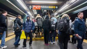 Travelers exit the Times Square subway station in New York on Saturday, March 19, 2016.  (© Richard B. Levine)