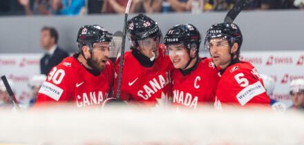 FRIBOURG, FRIBOURG - MAY 28: Canada players celebrate for the first time after Macklin Celebrini scored during the 2026 IIHF World Championship quarterfinal match between Canada and the United States at BCF Arena on May 28, 2026 in Fribourg, Fribourg, Swi