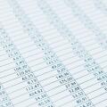 Business data report selective focus close up. Monthly stock stats spreadsheet. Blue toned.