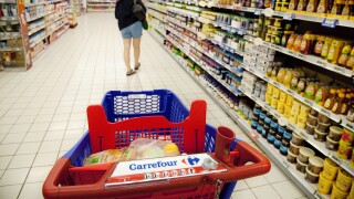 A woman shopping for food in the aisle of a Carrefour French supermarket, France Europe