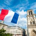 French flag flying in front of Notre Dame Cathedral in Paris, France