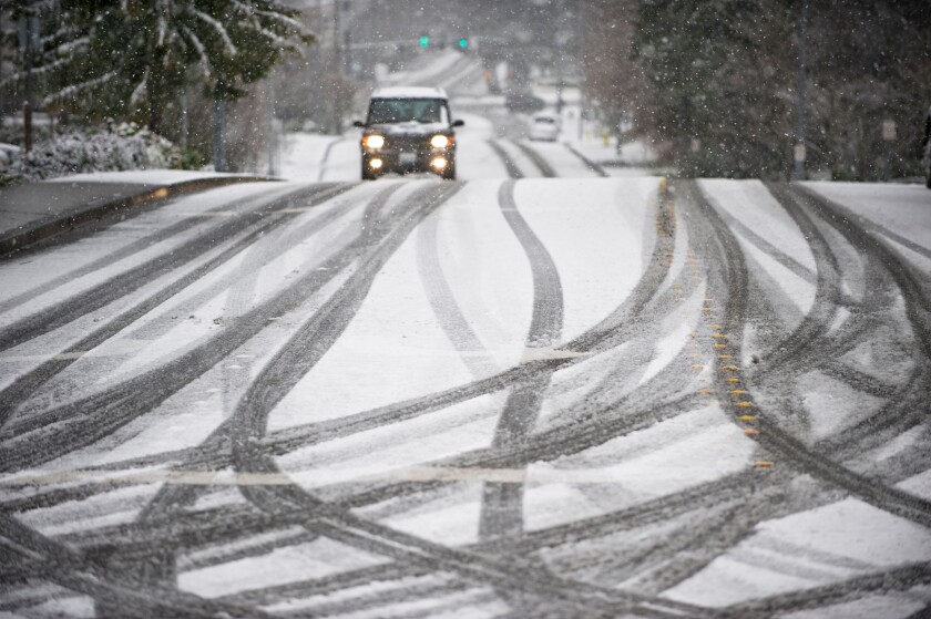 Car on road during snowstorm in Seattle Washington USA. Image shot 2009. Exact date unknown.