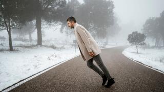 Mature man standing tilt on road during winter