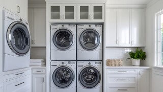 Modern laundry room with multiple washer dryers