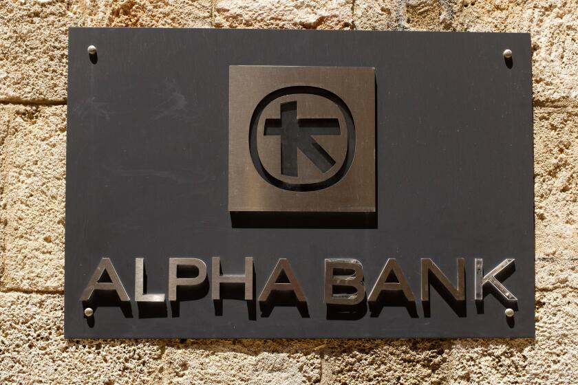 Sign for the Alpha Bank on a wall in Rhodes Old Town, Greece.