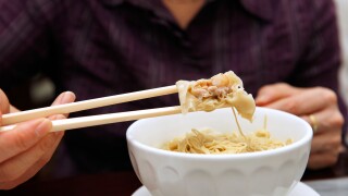 Customer tucks in to pork and shrimp wonton noodle soup served at a restaurant in Macau