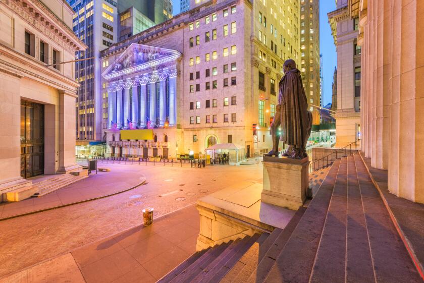 New York City in the Financial District on Wall Street at night.