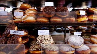 Doughnuts for sale on a market stall in Campden, London.. Image shot 04/2009. Exact date unknown.