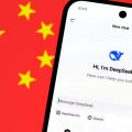 DeepSeek AI app chat seen on the smartphone and blurred Chinese flag on the background. Concept for a new chinese AI rival to ChatGPT