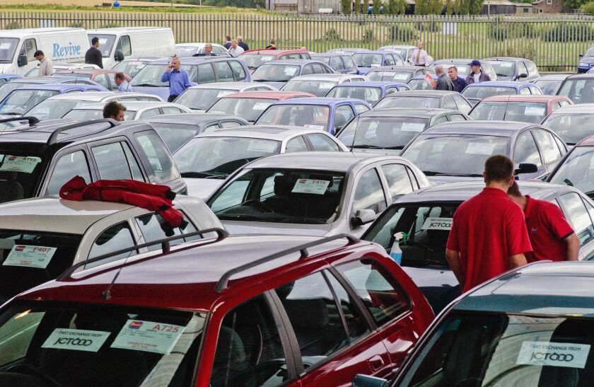 Buyers inspecting cars at a UK car auction