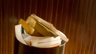 paperback books piled in trash can