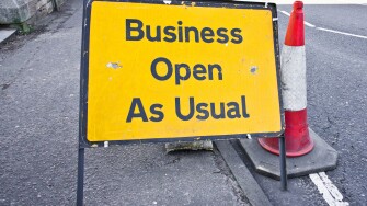 Road sign stating business open as usual during period of road works