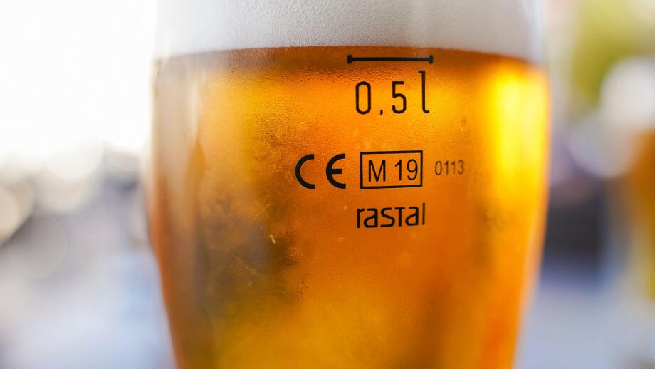 Cisal glass of full beer with CE Marking 0.5l  on table in Spain..