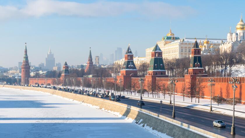Moscow cityscape - panoramic view of Kremlin along Kremlin embankment near frozen Moskva river in sunny winter day