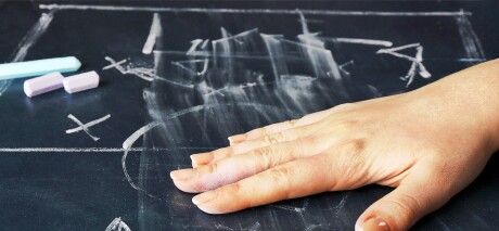 Hand erased scheme football game from blackboard background