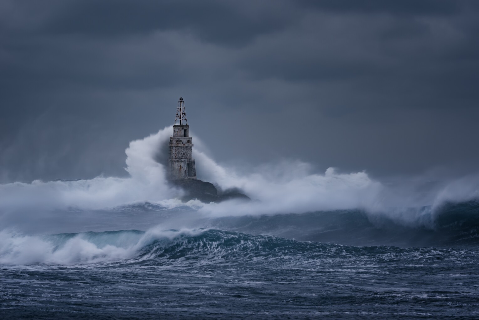 Stormy cloudy day. Dramatic sky and huge waves at the Lighthouse