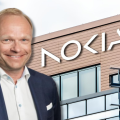 Departing Nokia CEO Pekka Lundmark superimposed in front of the faced of Nokia's headquarter building in Espoo, Finland