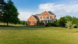Detached house USA - Front of large single American family home with large garden lawn on a warm sunny summer day