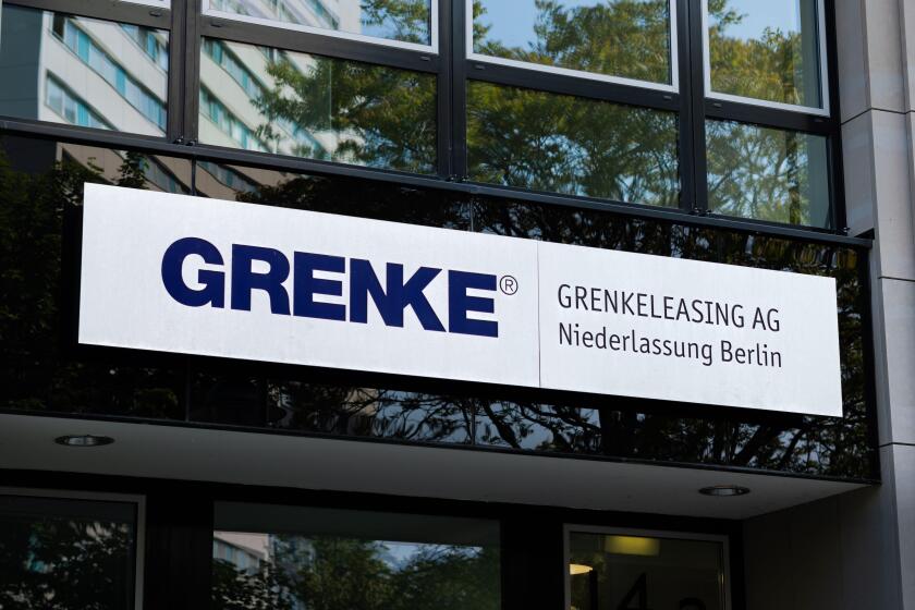 GRENKE logo sign of the leasing and banking company on the entrance of an office building. The German business operates in the financial sector.